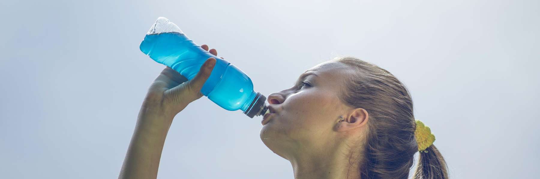 young woman drinking sugary sports drinks in narre warren
