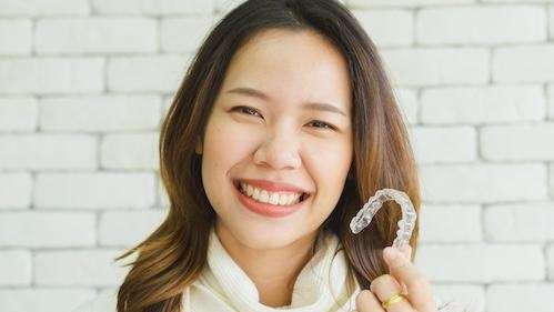 woman holding invisalign in narre warren