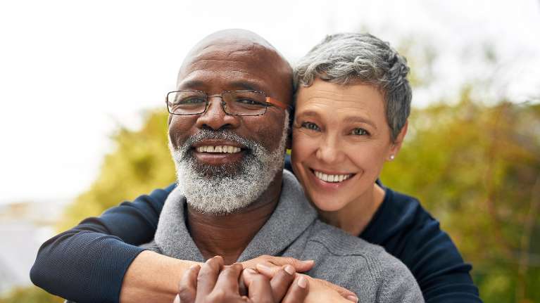older couple smiling with dental implants in narre warren
