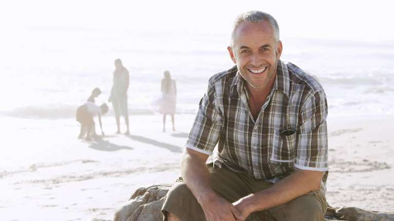 man with a bright white smile at the beach in narre warren